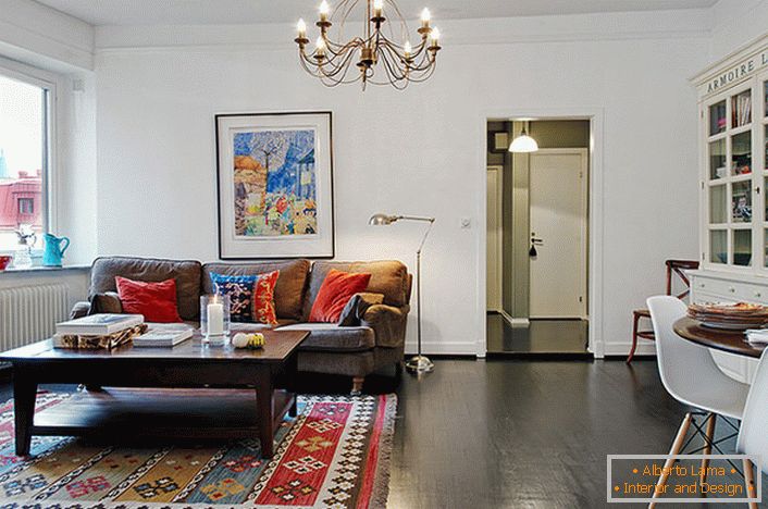 Um elegante quarto em um apartamento típico da cidade é decorado com travesseiros luminosos no sofá e carpete. 