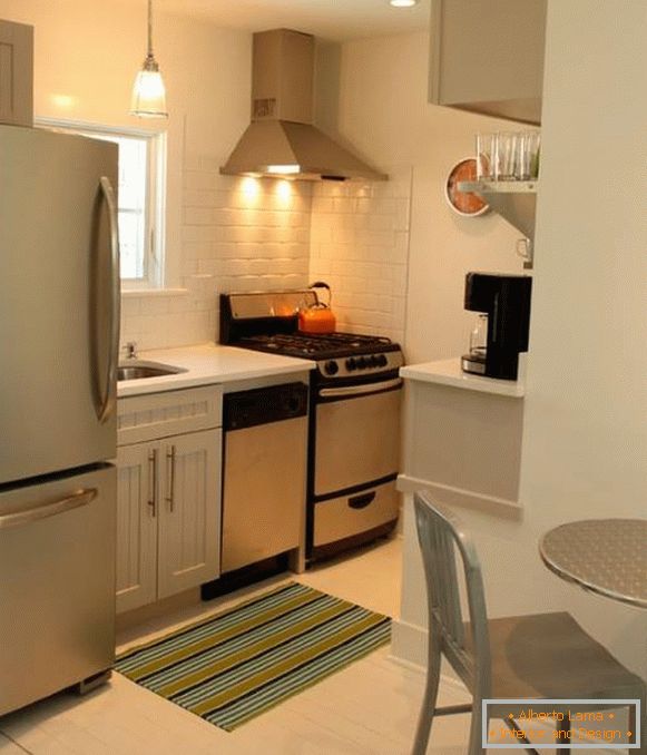 Design moderno de uma pequena cozinha com geladeira na foto