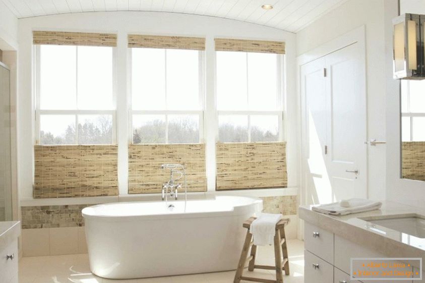 Banheiro caro com materiais naturais e grandes janelas