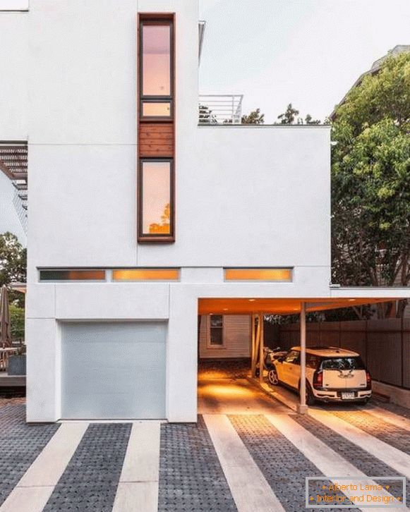 Casa no estilo do minimalismo com uma garagem para carros