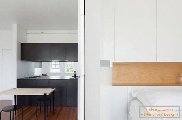 Parede modular no interior do apartamento: uma cozinha preta e um quarto branco como a neve