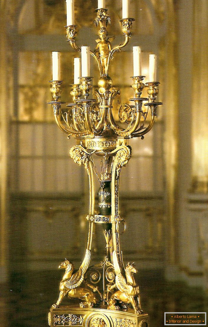 Um candelabro de ouro nobre e refinado para nove velas decorará o interior de qualquer casa de campo ou cabana de caça.
