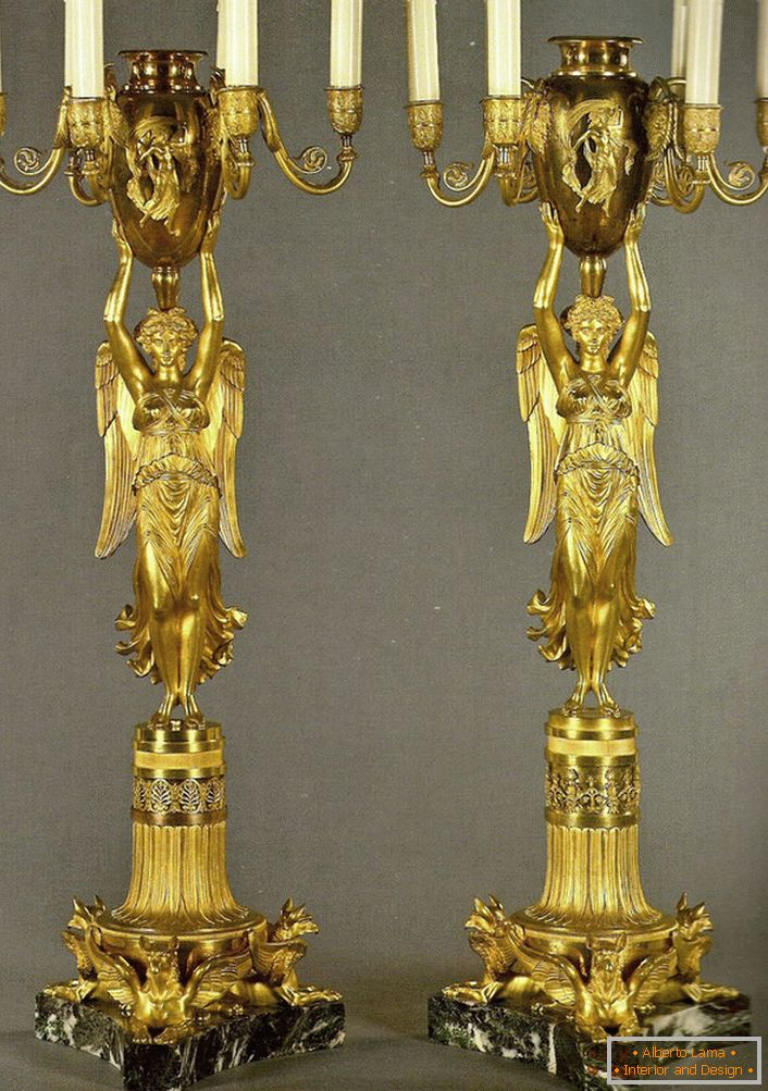 Um par de candelabros de ouro idênticos decoram o quarto em estilo barroco. 