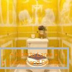 Telha amarela com ornamento branco no banheiro