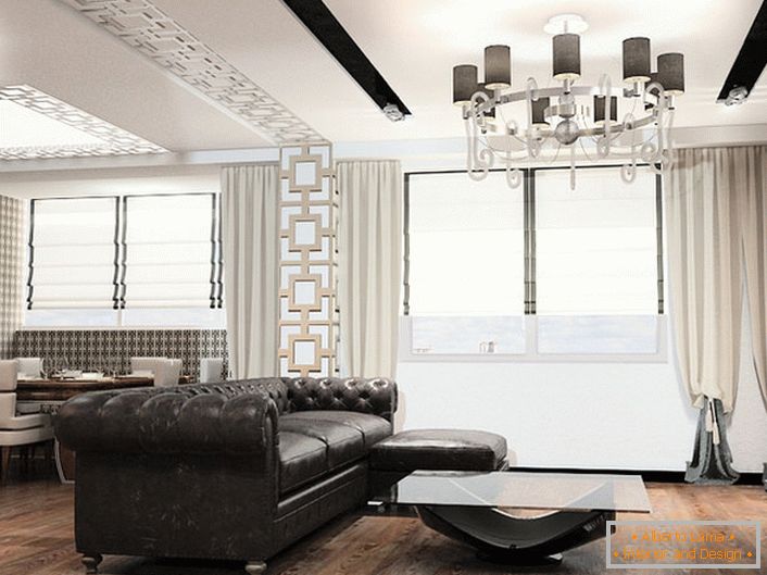 Mobiliário no estilo art déco é sempre mobiliário de grande porte. Ideal para decorar a sala de estar neste conceito estilístico é um sofá de couro com estofos acolchoados.